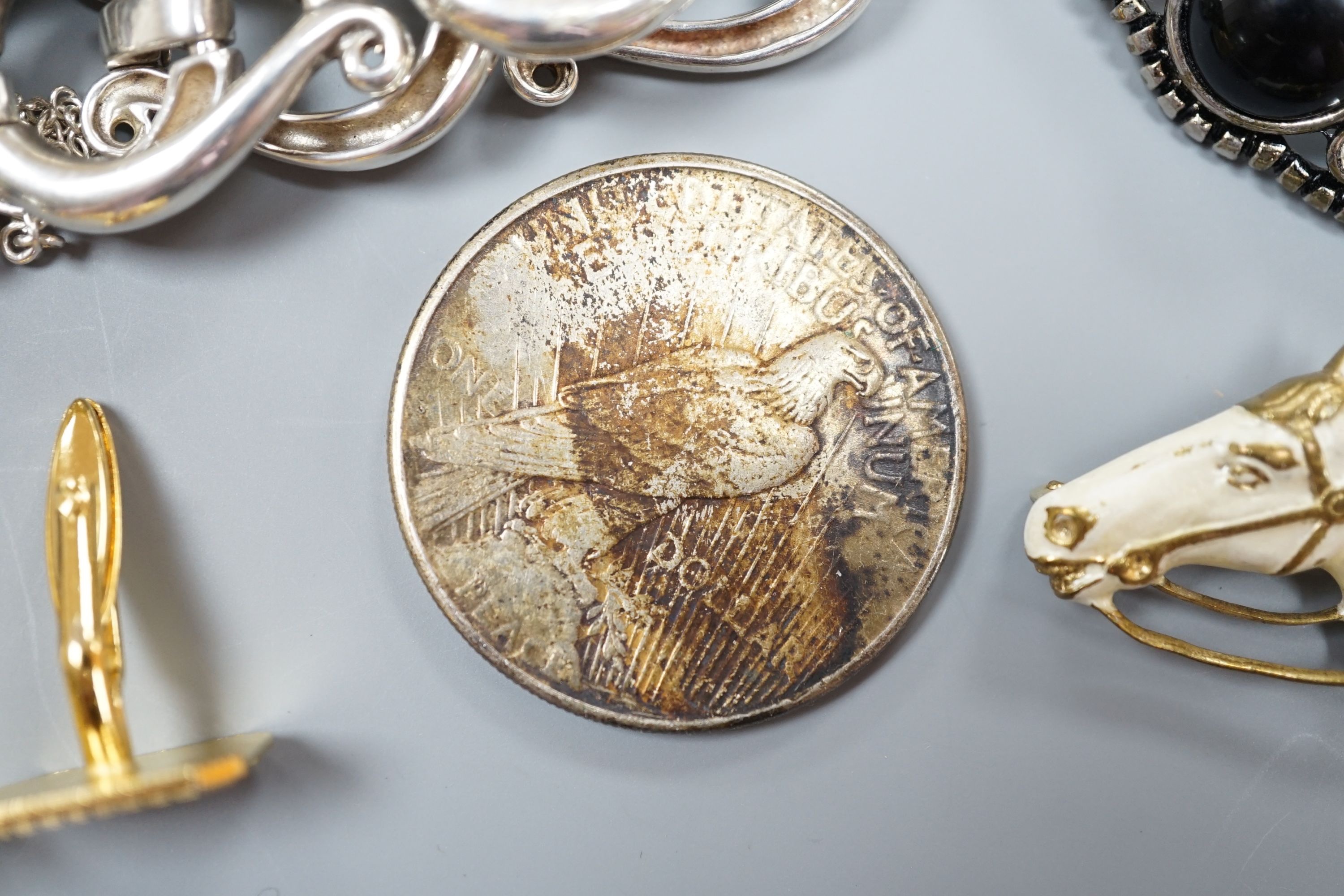 A white metal bracelet and minor jewellery and coins.